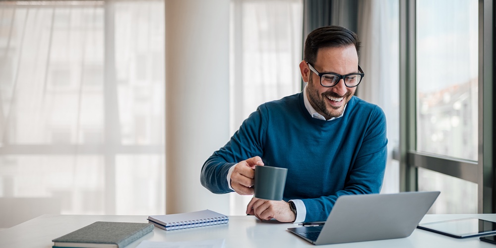 Cheerful Professional Analyzing Business Plan On Laptop. Male Executive Is Having Coffee While Worki|Smiling Businessman With Laptop Discussing On Smart Phone. Male Executive Multitasking While Working
