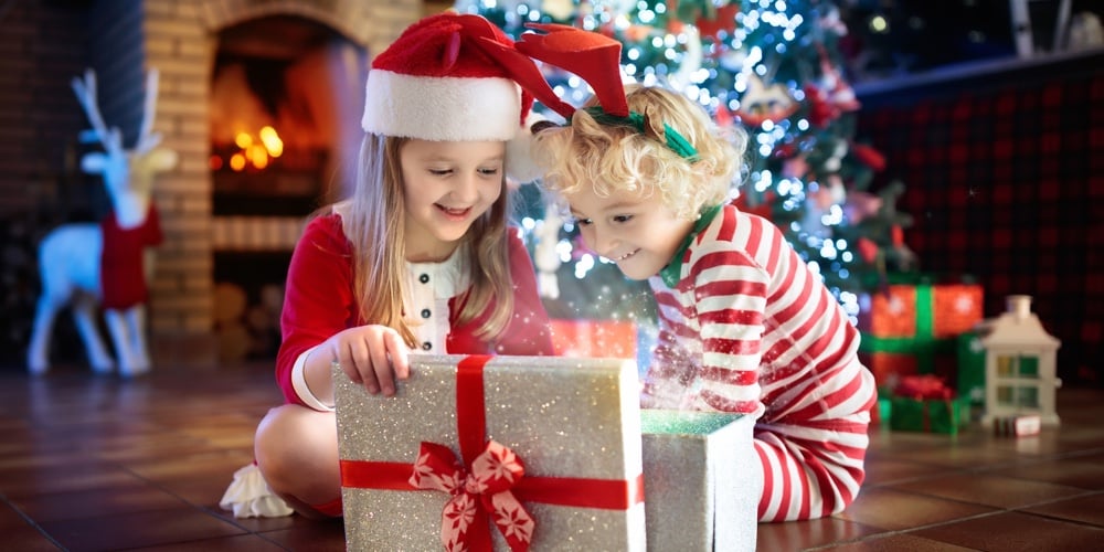 Child At Christmas Tree. Kids At Fireplace On Xmas