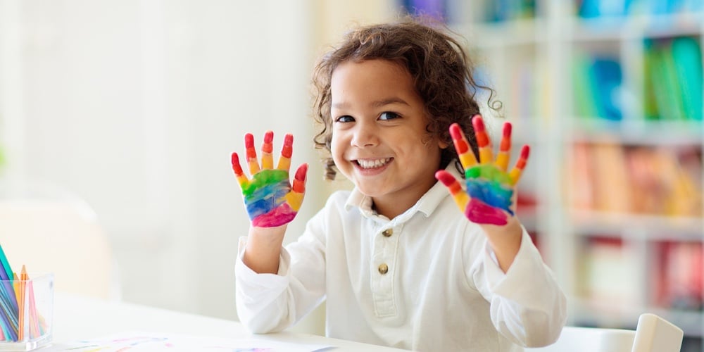 Child Drawing Rainbow. Paint On Hands. Remote Learning And Online School Art Homework From Home. Art