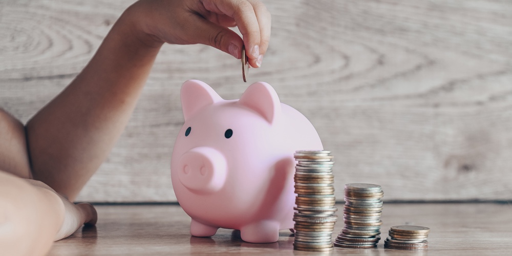 Child Woman Hand Putting Money Coin Into Piggy Bank For Saving Money For Education Study Or Investme