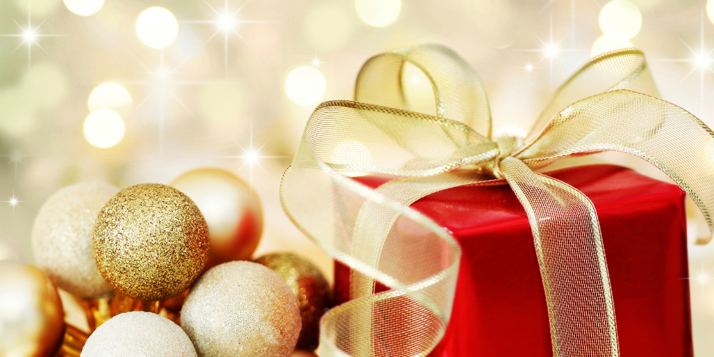 bigstock-Christmas-Gift-On-Defocused-Li-6064726