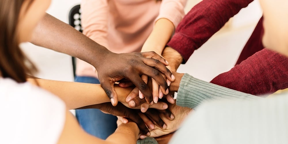Close Up High Angle View Of Diverse Young People Putting Their Hands Together – Support