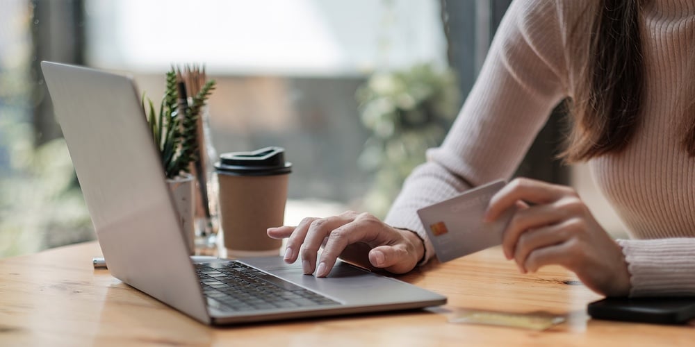 Close Up Of Black Girl Hold Bank Credit Card And Type On Laptop