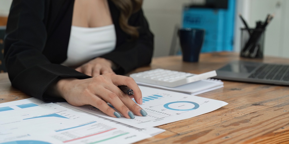 Close Up Of Businesswoman Hands Using A Calculator To Check Company Finances And Earnings And Budget