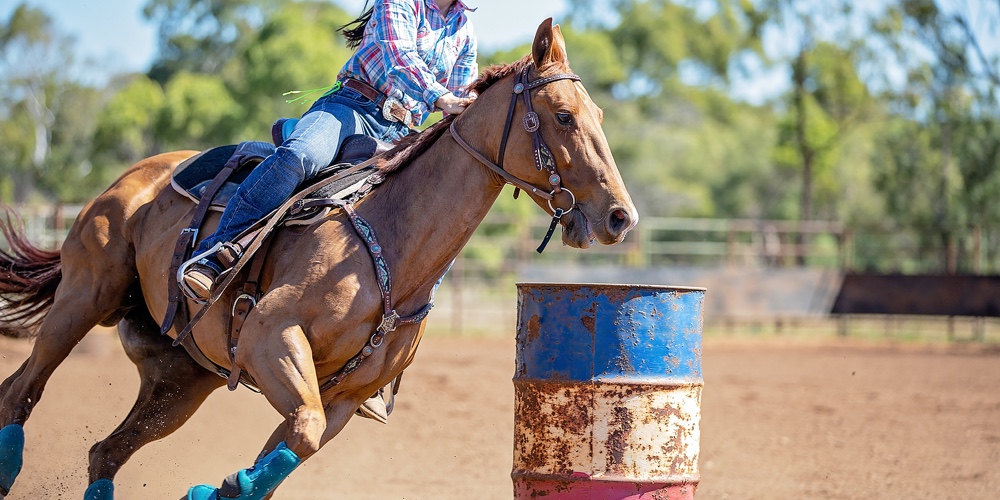 Close Up Of Competitor On Horseback Making A Figure Eight Turn In A Barrel Race At Outback Country R