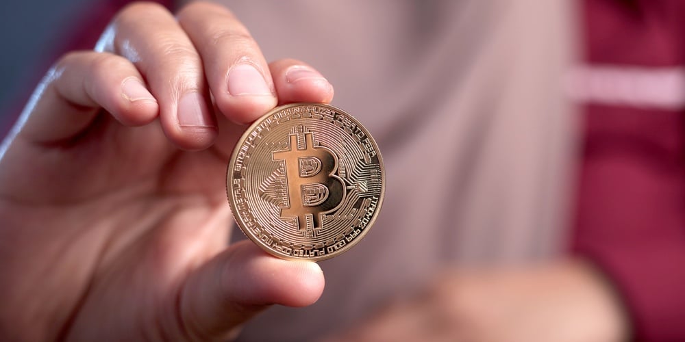 Close Up Of Female Showing Physical Bitcoin Cyptocurrency In Her Hand