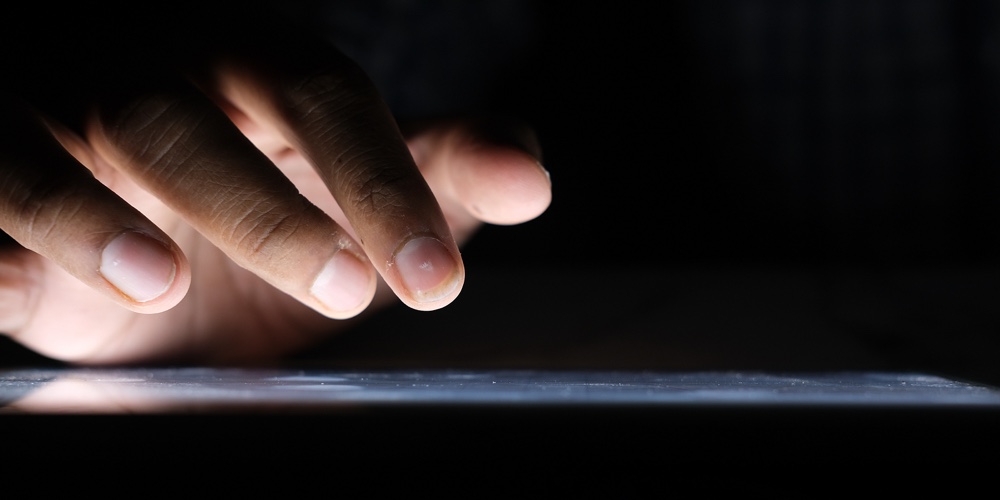 Close Up Of Hacker Hand Stealing Data From Digital Tablet