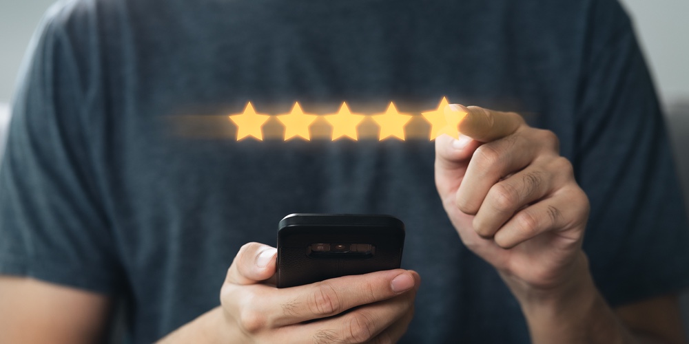 Close Up Of Man Customer Giving A Five Star Rating On Smartphone. Review