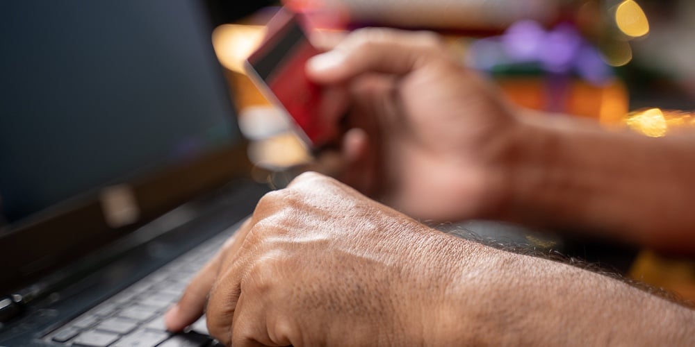 Close Up Of Old Man Hands Busy In Purchasing Or Doing Online Payment On Laptop During Holiday Season