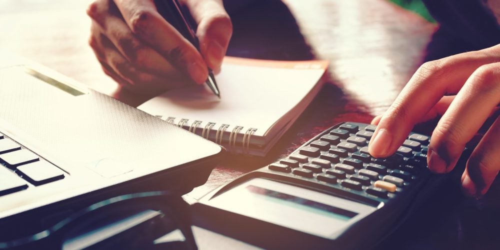 Close Up Woman Hand Using Calculator And Writing Make Note With