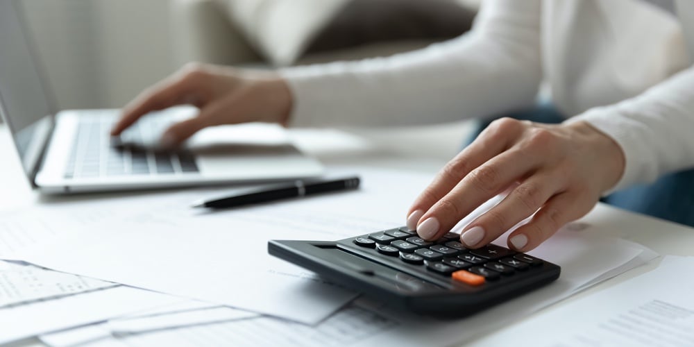 bigstock-Close-Up-Woman-Using-Calculato-384013130