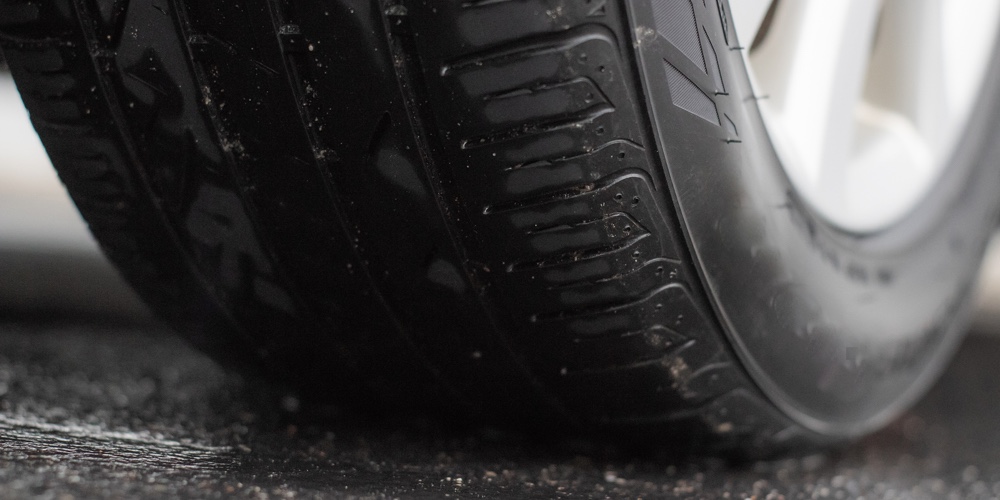 Closeup Car Tire Sitting On Wet Asphalt