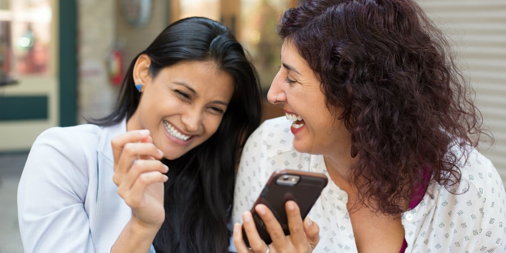 bigstock-Companions-Laughing-At-Texts-108532550