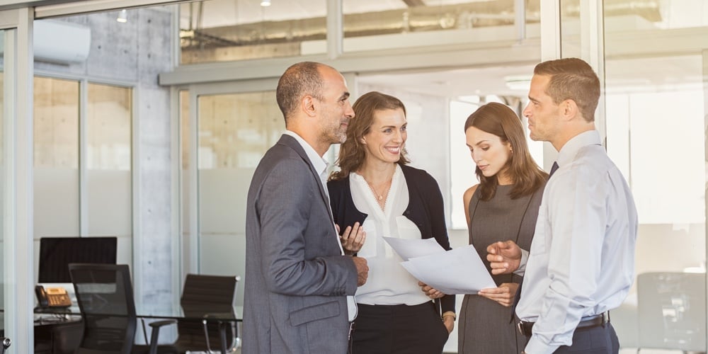bigstock-Company-employees-in-conversat-203276209