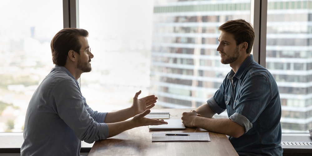 Confident Young Male Job Seeker Talking With Skilled Hr Manager.