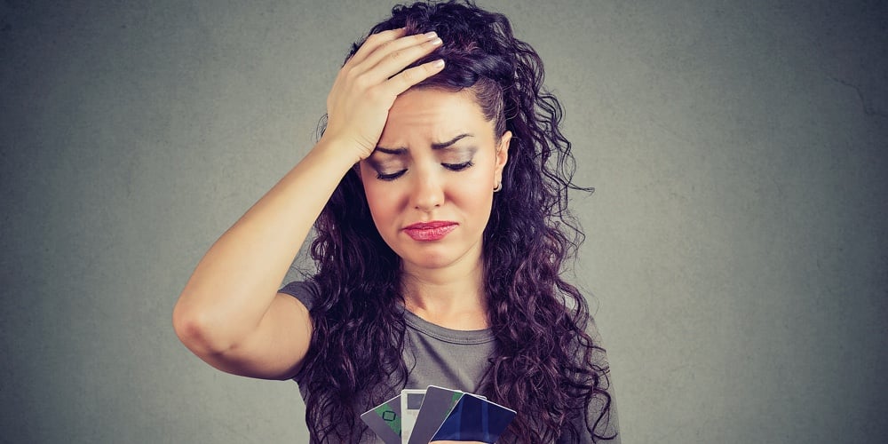 Confused Stressed Woman Looking At Too Many Credit Cards