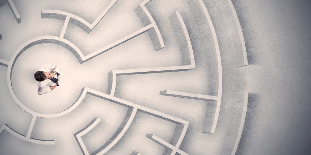 Confused business man trapped in a circular maze