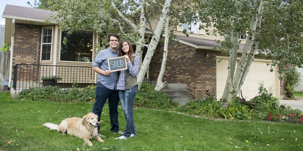 bigstock-Couple-outside-new-home-116702642