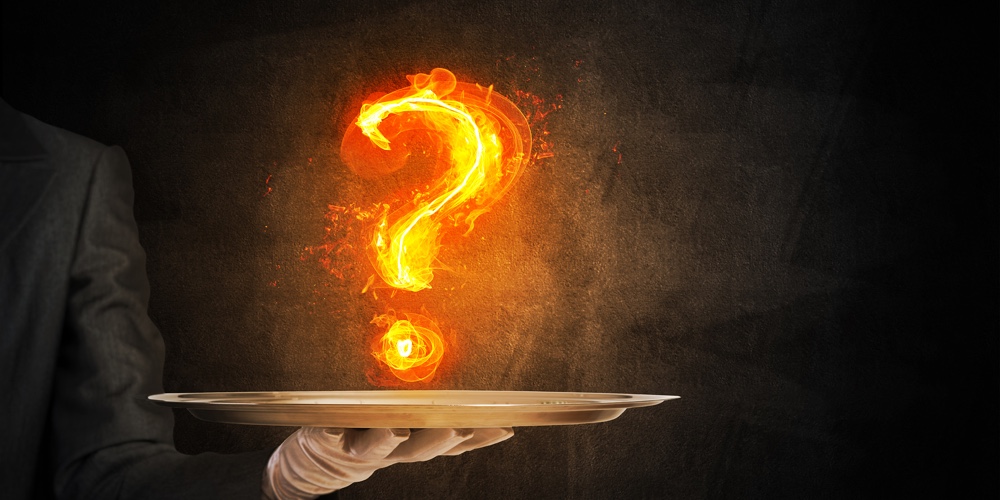 Cropped Image Of Waitresss Hand In White Glove Presenting Flaming Question Mark On Metal Tray With D