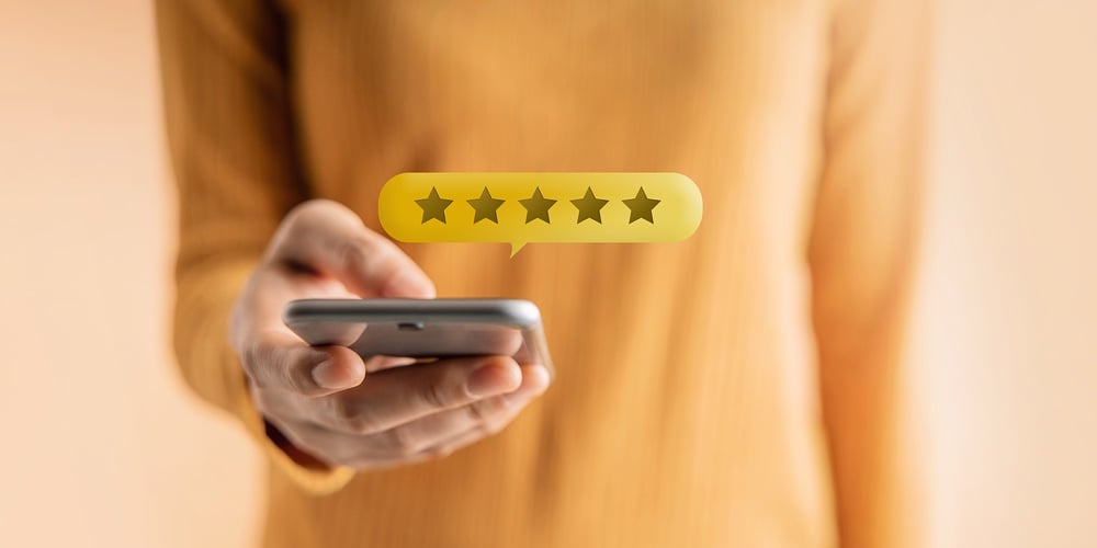Customer Experiences Concept. Happy Client Using Smartphone To Submit Five Star Review Rating For On