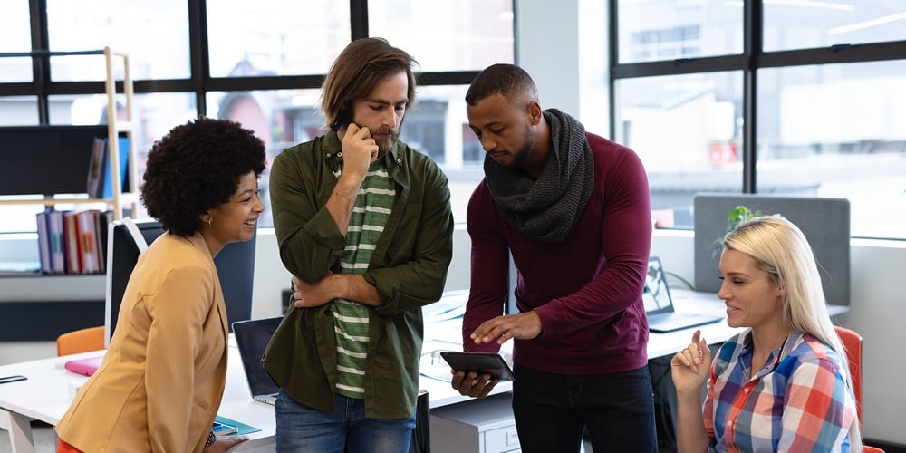 Diverse group of business people working in crative office. group of people using tablet computer an