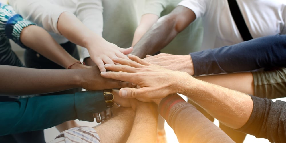 Diverse team joining their hands