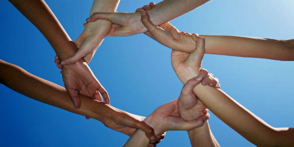 bigstock-Eight-Hands-Holding-Tight-8000934