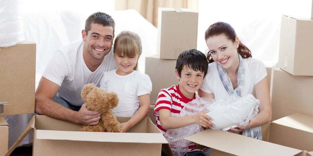 bigstock-Family-Moving-Home-With-Boxes-6143817
