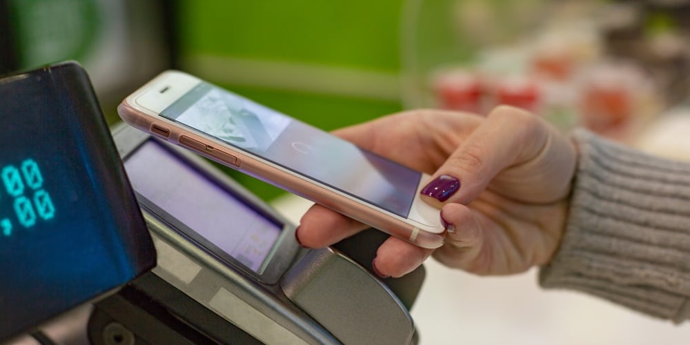 bigstock-Female-Paying-With-Nfc-Technol-245067601