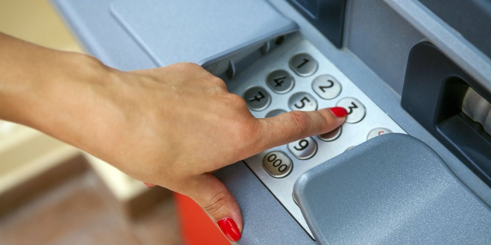 bigstock-Female-arms-ATM-entering-pi-95987018