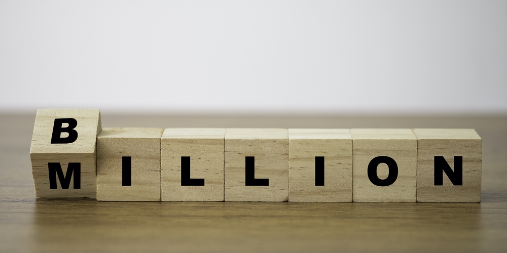 Flipping Of Wooden Cube Block For Change Million To Billion. Business And Investment Growth Concept.