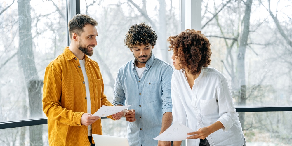 Friendly Multiracial Business Partners Gathered In Meeting Room
