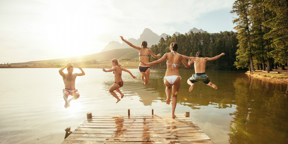 bigstock-Friends-Jumping-Into-The-Water-119847851