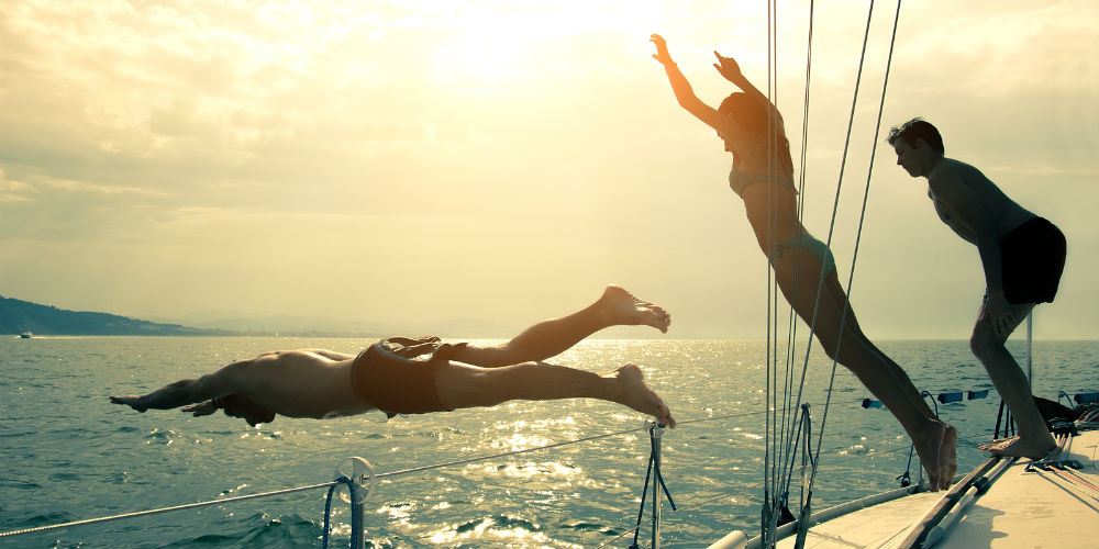 bigstock-Friends-Jumping-Into-Water-Fro-75657751
