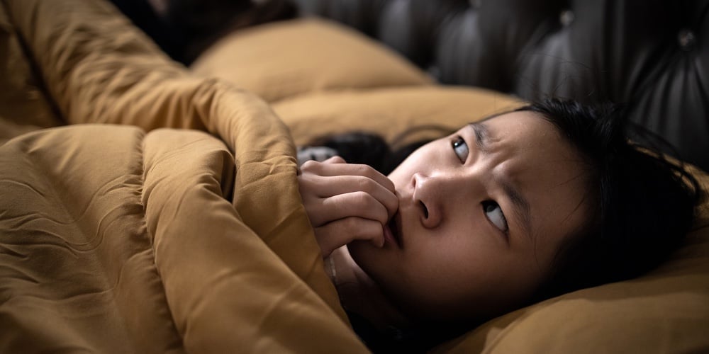 Frightened Asian Child Girl Is Looking Around And Nail Biting