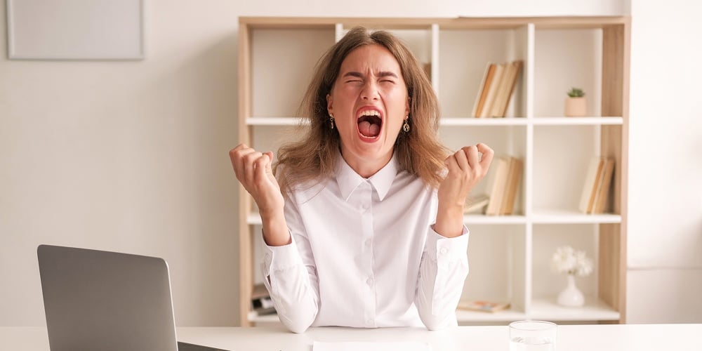 Furious Rage. Screaming Woman. Work Problem. Mad Lady Sitting Desk With Laptop Expressing Aggression