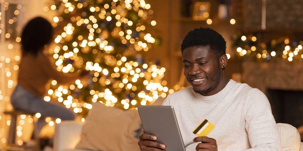Glad Millennial Black Man With Tablet And Credit Card Enjoy Online Shopping