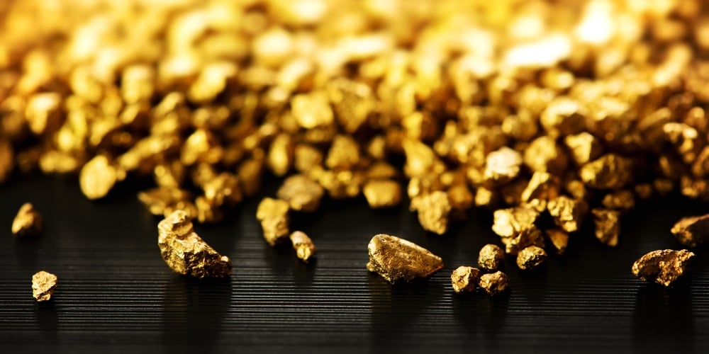 bigstock-Gold-nuggets-spilling-out-on-b-229736941