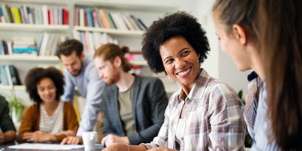 Group Of Business People Collaborating On Project In Office