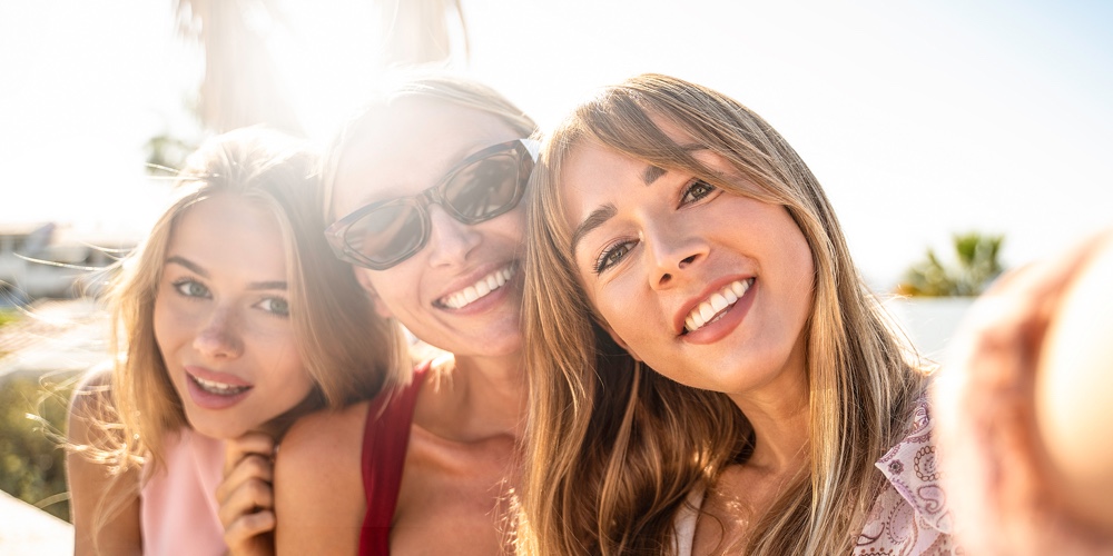 Group Of Female Caucasian Friends Taking Selfie For A Social Media. Three Young Women Smiling. Real