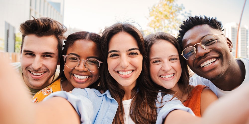 Group Of Happy Multiracial Teenagers Having Fun Smiling Taking A Selfie Portrait Together On A Stude