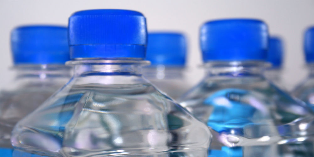 Hand holds a bottle of water isolated on white|bigstock-Group-Of-Square-Water-Bottles-2343147