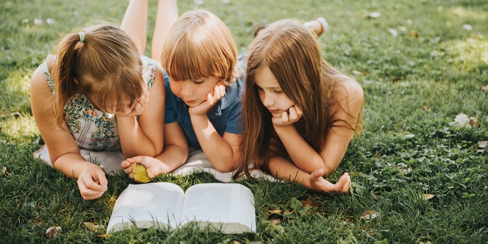 bigstock-Group-Of-Three-Kids-Lying-On-G-227307049