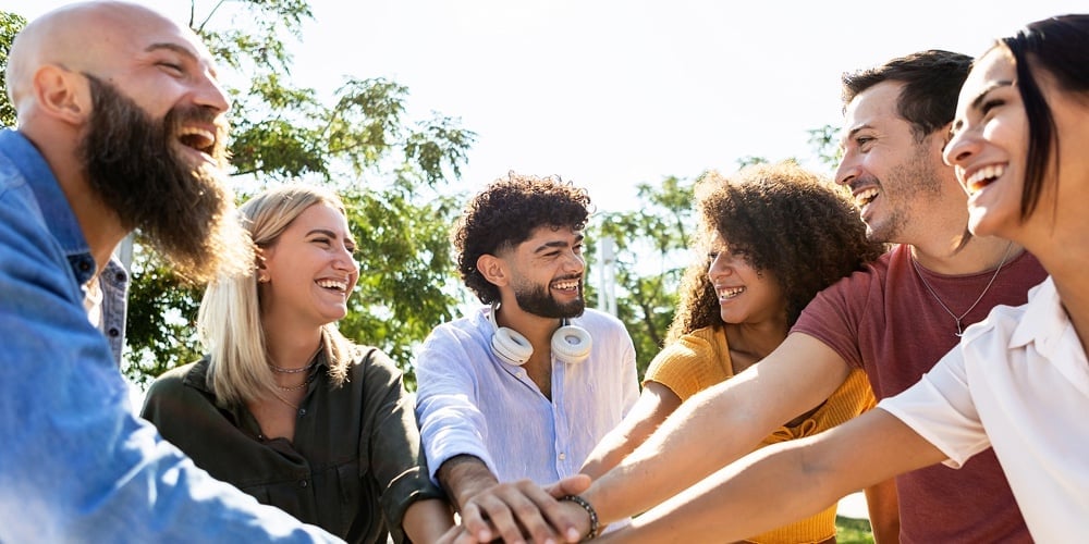 Group Of United Multiracial People Stacking Hands Together – Cooperation