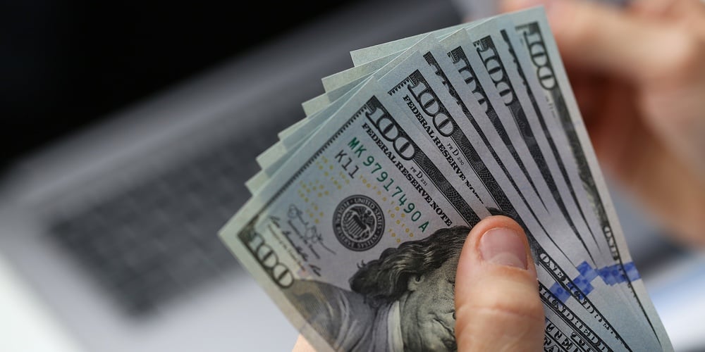 Hand Holds Paper Currency And Credit Bank Card. Deposit Investment And Banking Services