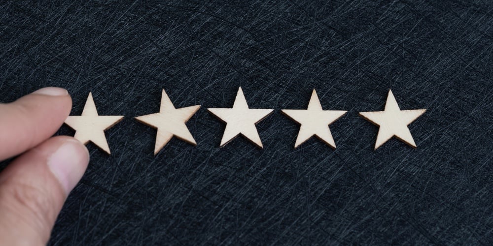 Hand Putting 5 Stars On Dark Texture Black Background With Copy Space Using As Customer Experience