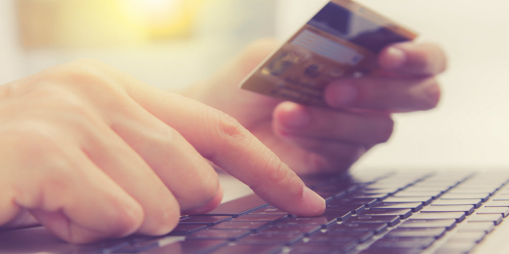 bigstock-Hands-Holding-Credit-Card-And-135890417