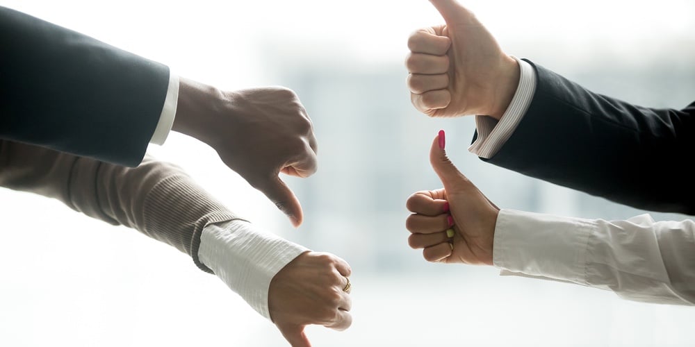 Hands Of Diverse Business People Showing Thumbs Up And Down