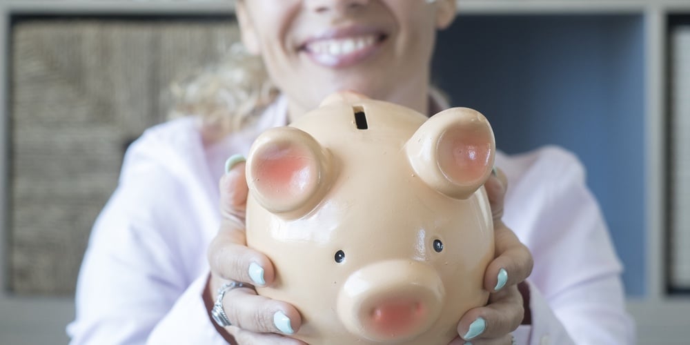 Hands Of Happy Woman Showing Piggy Bank To Save Money. Concept Of Saving Money For Vacation Or Futur