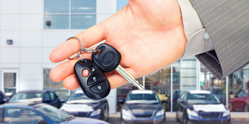 bigstock-Hands-with-car-keys-Dealer-an-24849134